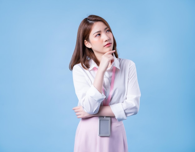 Image of young Asian businesswoman on blue background