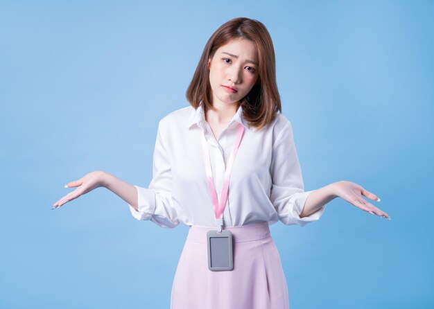 Image of young Asian businesswoman on blue background