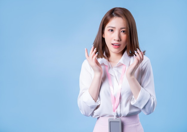 Image of young Asian businesswoman on blue background