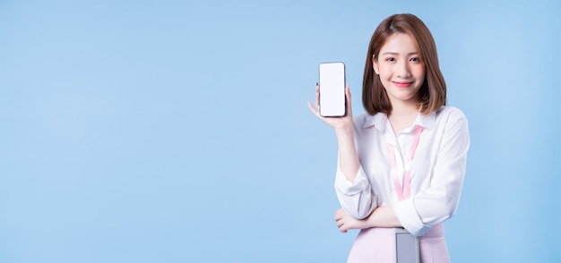 Image of young Asian businesswoman on blue background