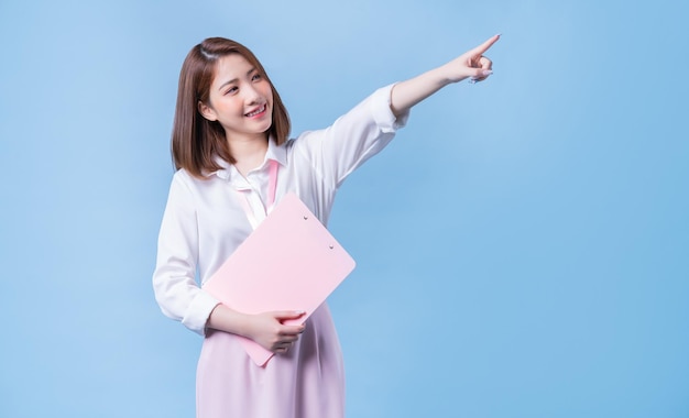 Image of young Asian businesswoman on blue background