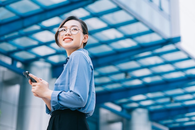 Image of young Asian businesswoman outside