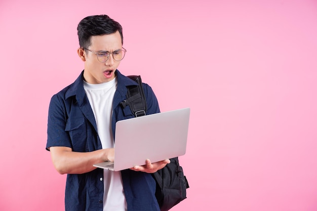 Image of young Asian college student on pink background