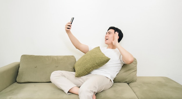 Image of young Asian man at home