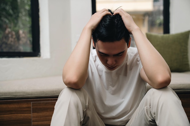 Image of young Asian man at home