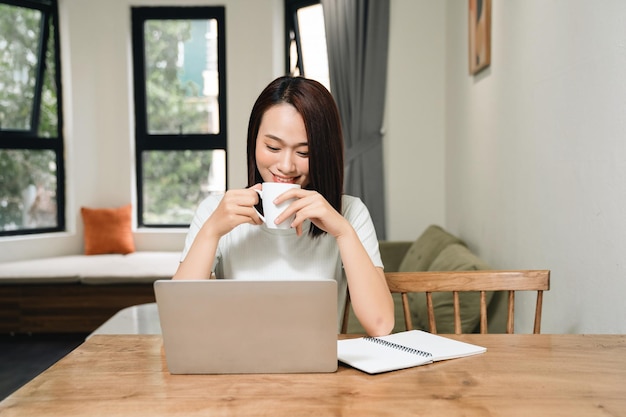 Image of young Asian woman at home