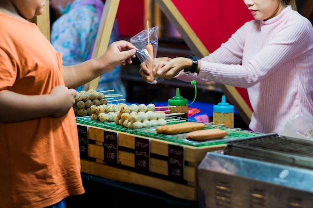 Images of vendors and customers trading in food.