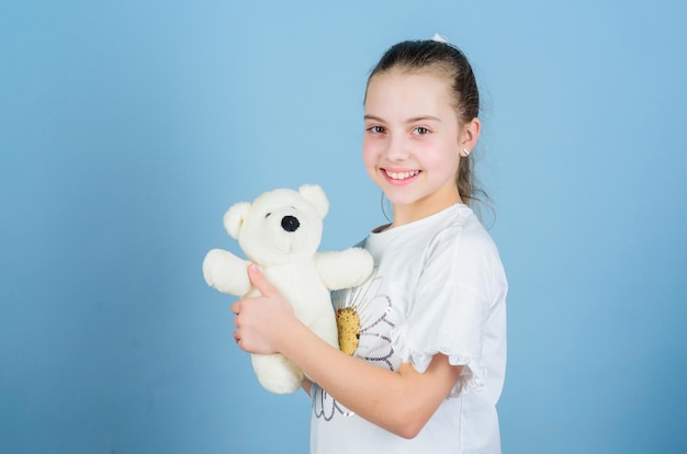 Imaginary friend Little girl play with soft toy teddy bear Child care Sweet childhood Childhood concept Lovely small girl smiling happy face with favorite toy Best friends Happy childhood