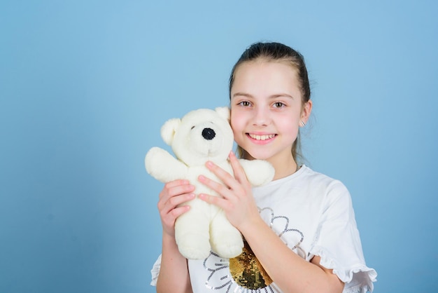 Imaginary friend Little girl play with soft toy teddy bear Happy childhood Child care Sweet childhood Childhood concept Lovely small girl smiling happy face with favorite toy Best friends