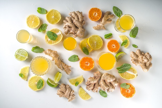 Immunity booster drink ingredients. Homemade ginger and citrus juice or cocktail, with fresh citrus fruit - orange, lemon, lime, with ginger root and mint