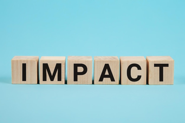 Impact word on wood blocks concept business improvement personal development and growth concept impa