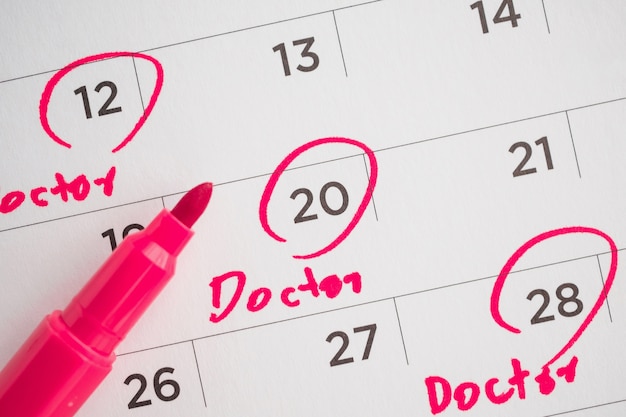 Important doctor appointment schedule write on white calendar