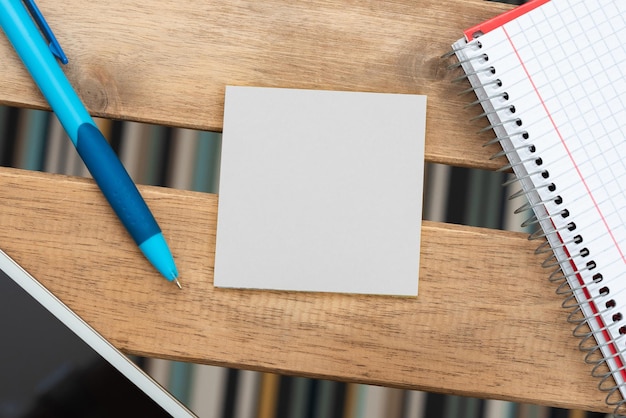 Important message on notebook on desk with money pen notes paper wraps and pig box critical