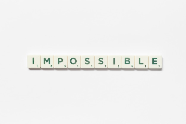 Impossible formed of scrabble tiles on white background