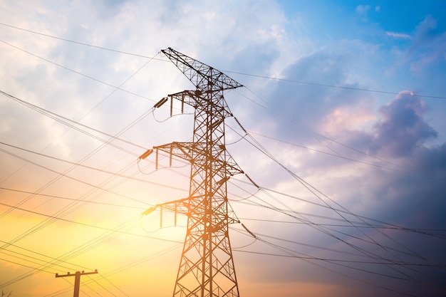 Impression network at transformer station in sunrise, high voltage up to yellow sky take with yellow tone