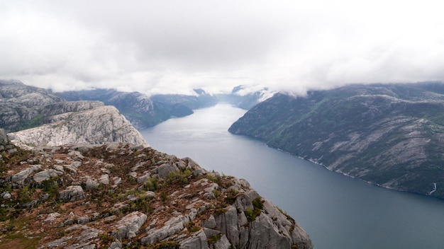 Impressive Lysefjord between high mountains on a cloudy day passing Preikestollen