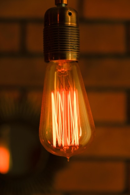 Incandescent lamp on a dark background filament spiral