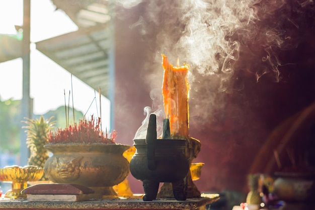 Incense sticks on joss stick pot are burning and smoke use for pay respect to the Buddha, respect to the Buddha in Buddhism life Pray in buddha.