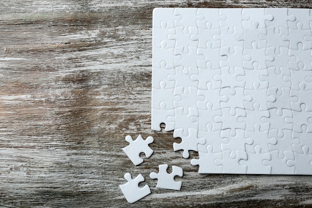 Incomplete puzzles on wooden table