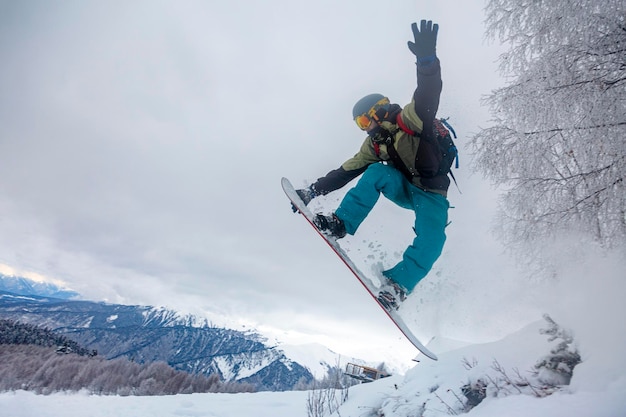 Incredible snowboard jump under the white snowy forest in a good winter day freeride in a deep snow ski season