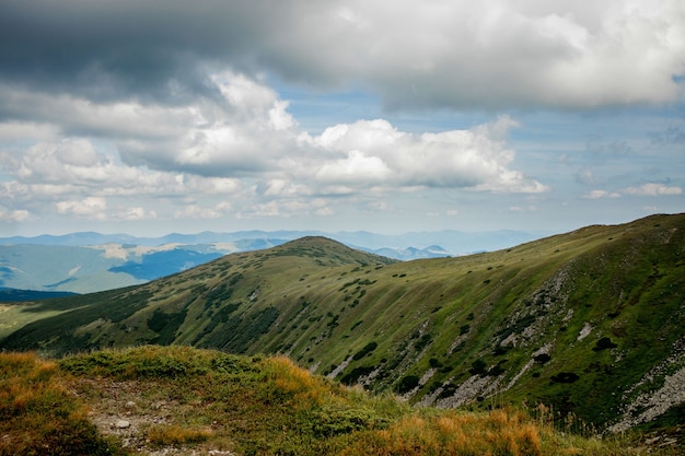 Incredibly beautiful panoramic views of the Carpathian Mountains. Peaks in the Carpathians on a background of blue sky.