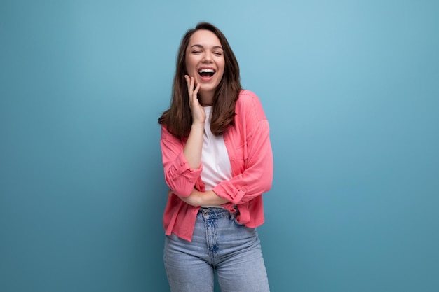 Incredibly smiling happy young lady in a stylish summer look on a studio isolated background