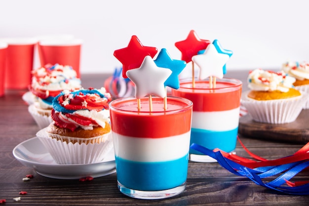 Independence Day Fourth of July USA American patriotic party with american symbols Glasses of tasty dessert layered colorful jelly with star hard rock caramel