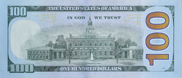 Independence Hall on 100 dollars banknote back side closeup macro fragment. United states hundred dollars money bill