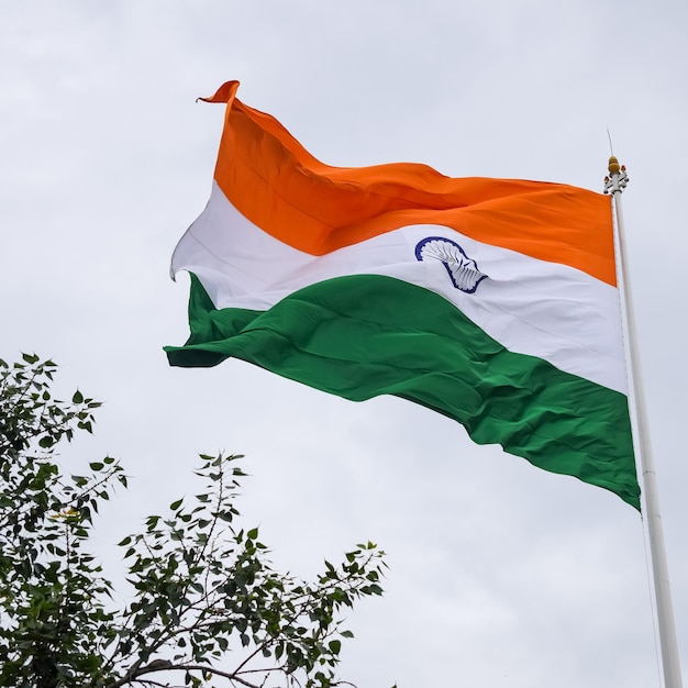 India flag flying high at connaught place with pride in blue sky india flag fluttering indian flag