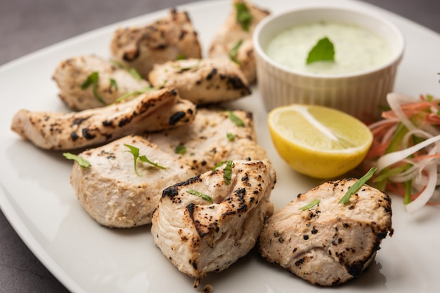 Indian Afghani chicken Malai Tikka is a grilled Murgh creamy kabab served with fresh salad