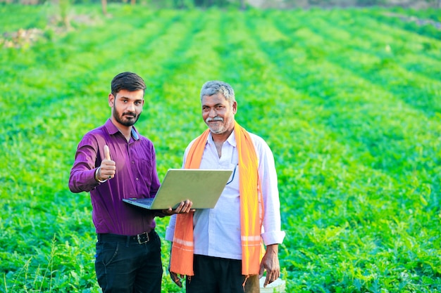 indian agronomist with farmer at field