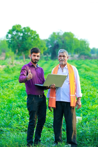 indian agronomist with farmer at field