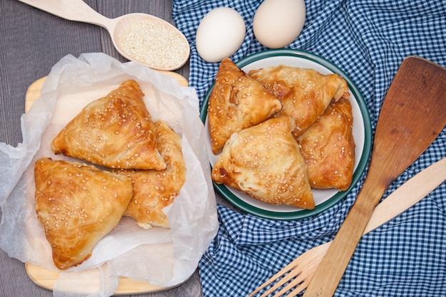 Indian, Asian food delicious samsa or samoses on wooden background. Top view, flat lay.