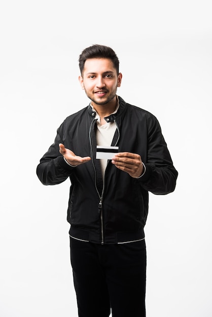 Indian asian man with credit or debit card or electronic plastic swipe card, isolated over white background