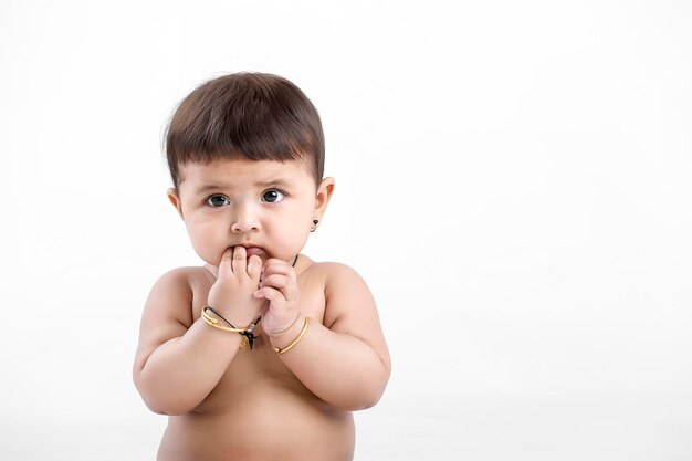 Indian baby girl playing on white background