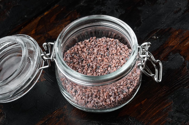 Indian Black salt, Kala namak hindi Healthy food concept set, in glass jar, on old dark  wooden table background