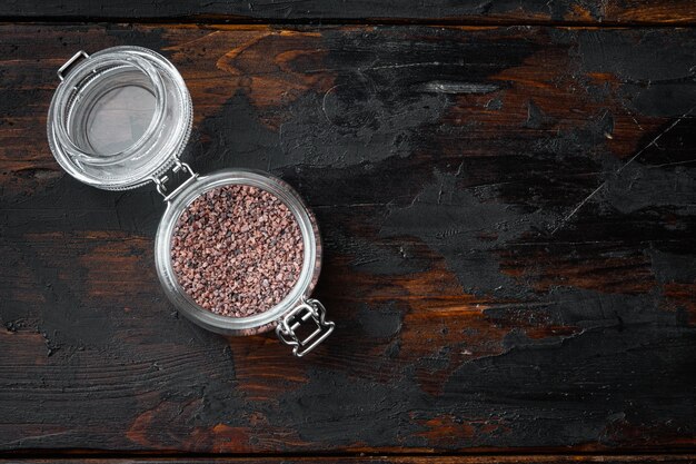 Indian Black salt, Kala namak hindi Healthy food concept set, in glass jar, on old dark  wooden table