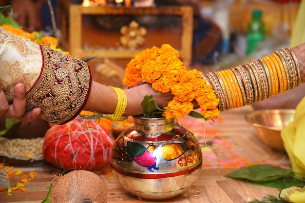 An Indian bride and groom holding their hands during a Hindu wedding