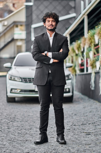 Indian businessman in the background of a car.