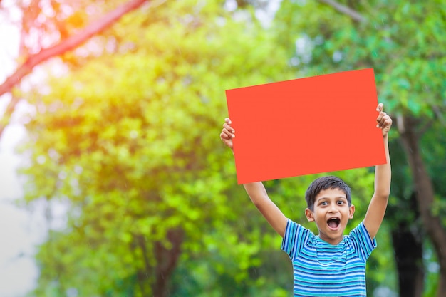 indian child holding empty poster