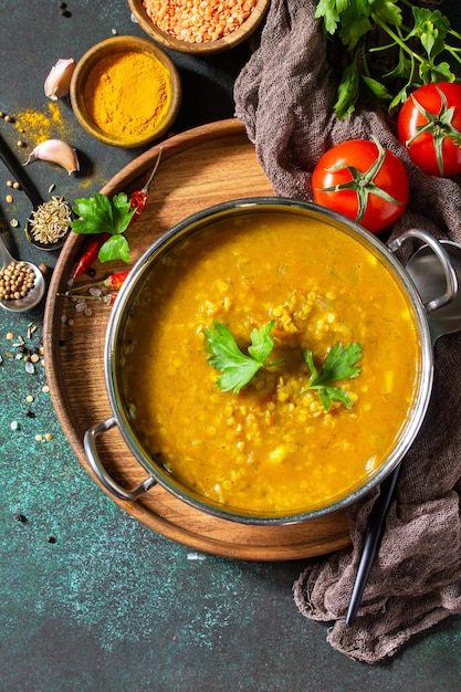 Indian cuisine Traditional Indian spicy lentil puree soup with herbs Top view Copy space