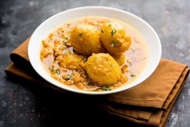 Indian Dum aloo curry using fried potatoes and spices, served in a bowl