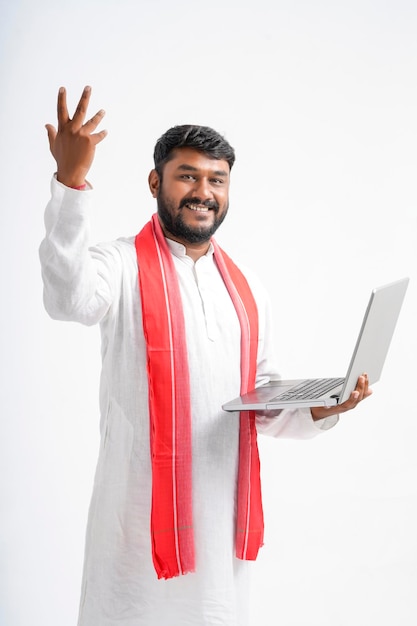 Indian farmer using laptop on white background