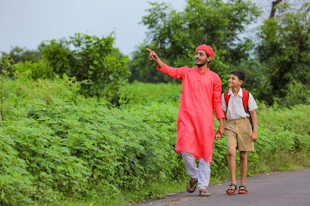 Indian farmer with his child on the road