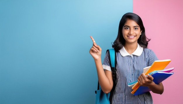 Indian female college student pointing confidently while holding notebooks Education Concept