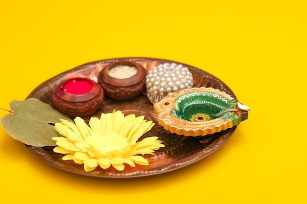 Indian festival diwali concept Traditional puja thali on yellow background