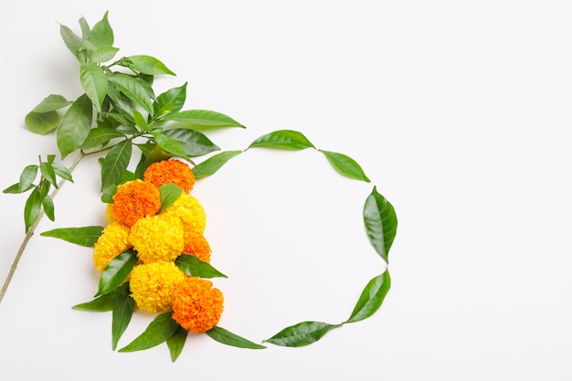 Indian festival dussehra greeting green leaf with marigold flower on white background