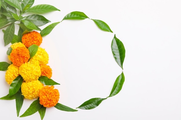 Indian festival dussehra greeting green leaf with marigold flower on white background