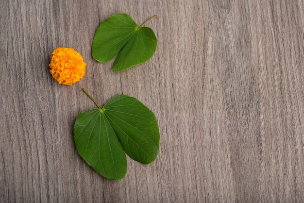 Indian Festival Dussehraand marigold flowers on a wooden background.