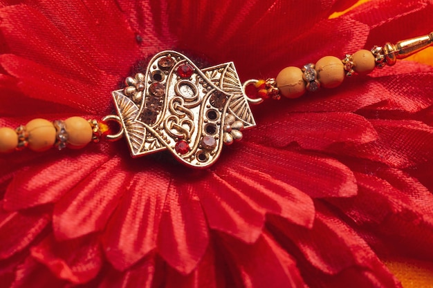 Indian festival Raksha Bandhan A traditional Indian wrist band on red background